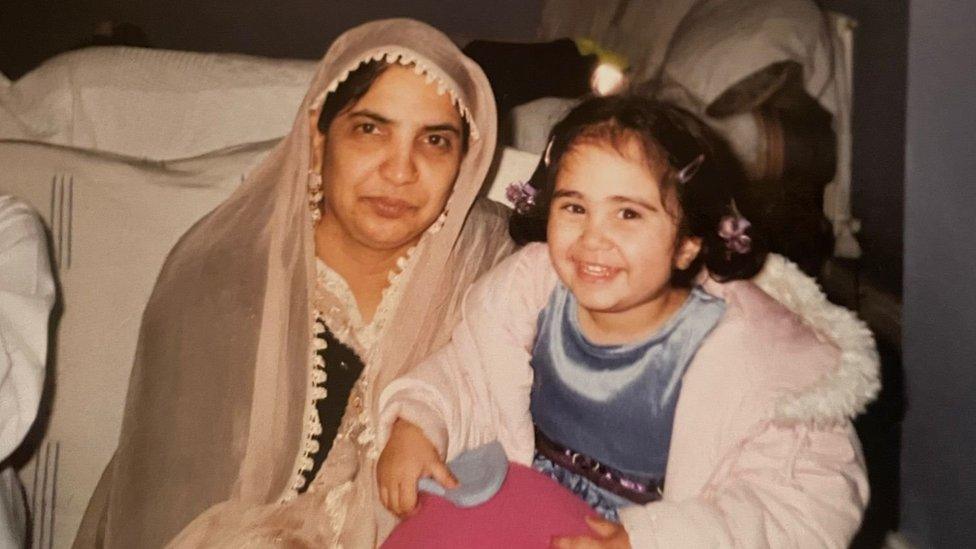 Angelina Aziz, as a child, with her grandmother