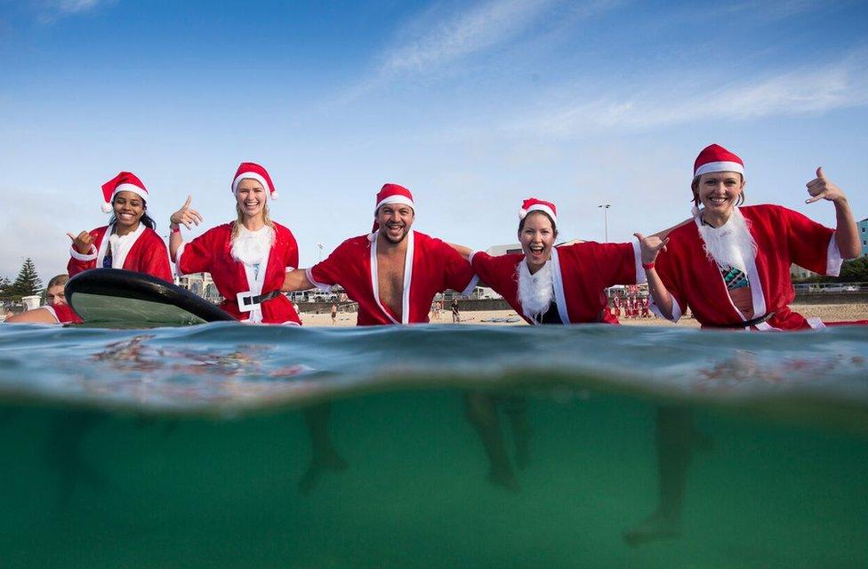 A pack of 320 surfing Santas embrace the Christmas spirit in Australia, breaking the Guinness World Record for the largest surf lesson.