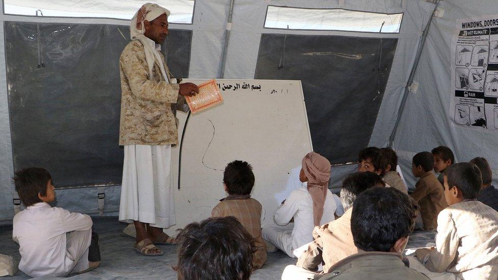 Yemeni students study in a tent after their school was damaged in fighting in the northern province of Saada