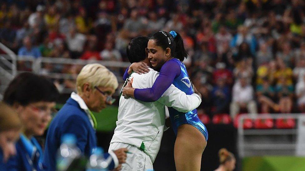 India's Dipa Karmakar (R) embraces her coach after competing in the women's vault event final of the Artistic Gymnastics at the Olympic Arena during the Rio 2016 Olympic Games