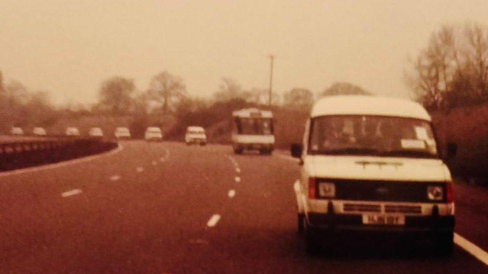 Vans in convoy carrying police