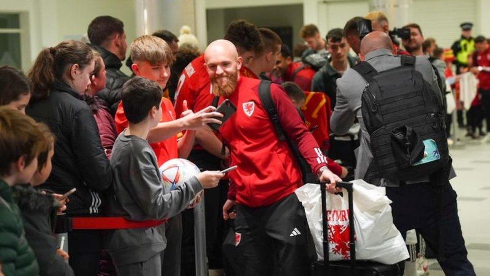 Midfielder Jonny Williams smiles for the camera at arrivals