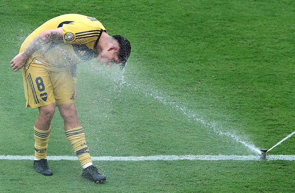 Carlos Palacios Boca Juniors uses a sprinkler on the pitch to cool down during the match against Auckland City in Nashville, Tennessee. Photo by Richard Pelham
