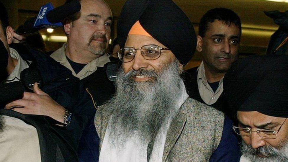 Sikh activist Ripudaman Singh Malik (centre) smiles as he leaves a Vancouver court March 16, 2005, after being found not guilty in the 1985