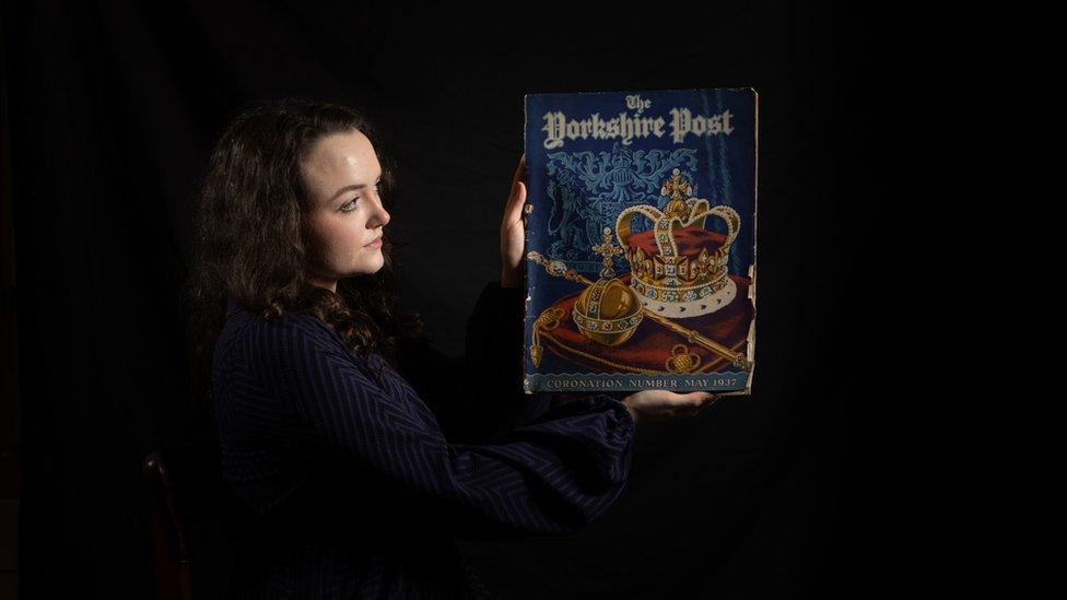 A woman holds up a Yorkshire Post item