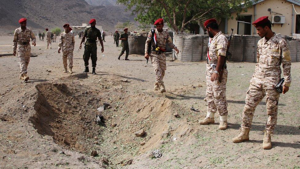 Soldiers are seen at the scene of the blast after a missile attack on a military parade