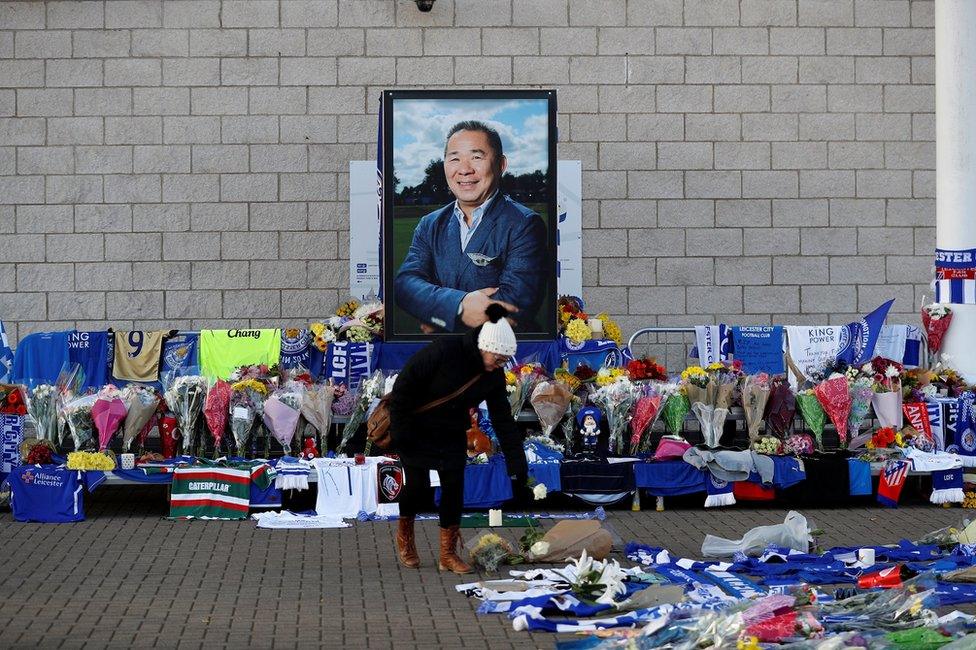 A woman places flowers outside Leicester City's King Power stadium, after the club's owner Thai businessman Vichai Srivaddhanaprabha and four other people died when the helicopter they were travelling in crashed as it left the ground after the match on Saturday, in Leicester, Britain, October 29, 2018