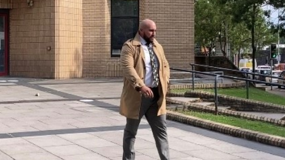 Rowan Knight walking away from court