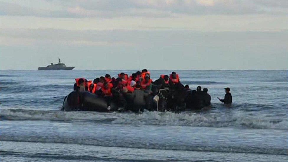 People boarding a migrant boat in Calais, France