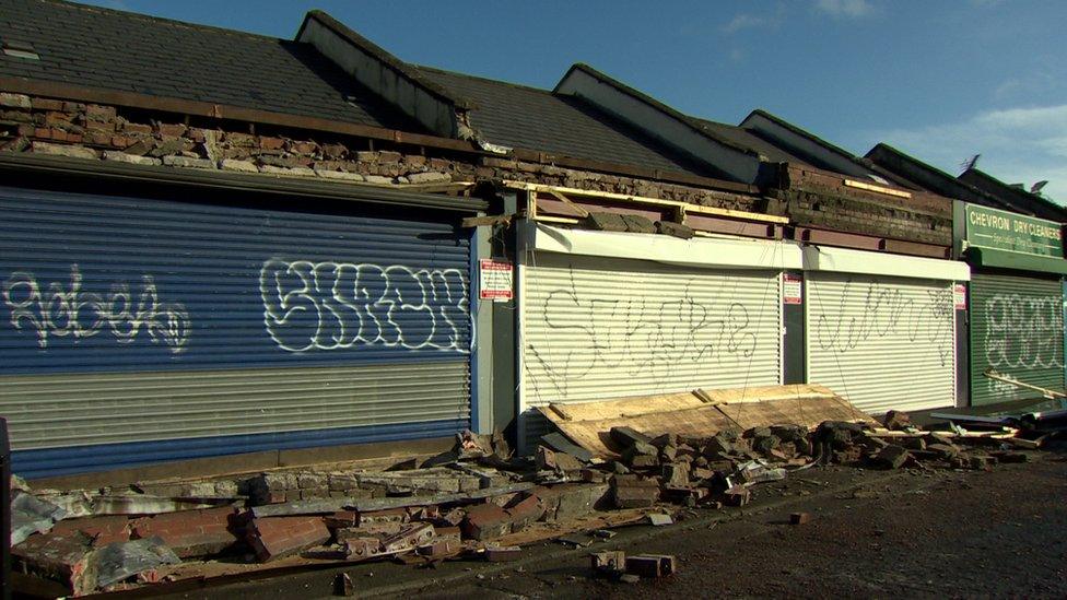 Front of shops showing storm damage