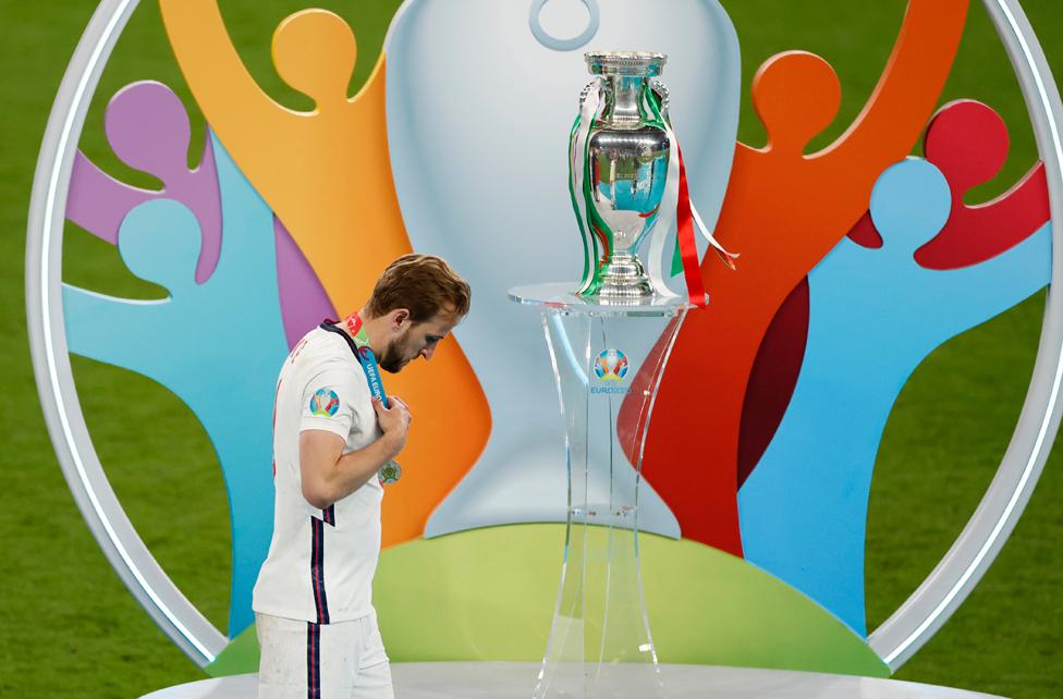 Harry Kane of England walks past the Henri Delaunay Trophy following his team's defeat in the UEFA Euro 2020 Championship Final between Italy and England at Wembley Stadium on July 11, 2021 in London, England.