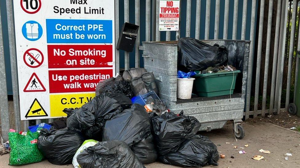 Rubbish in bin bags dumped in front of tip gates