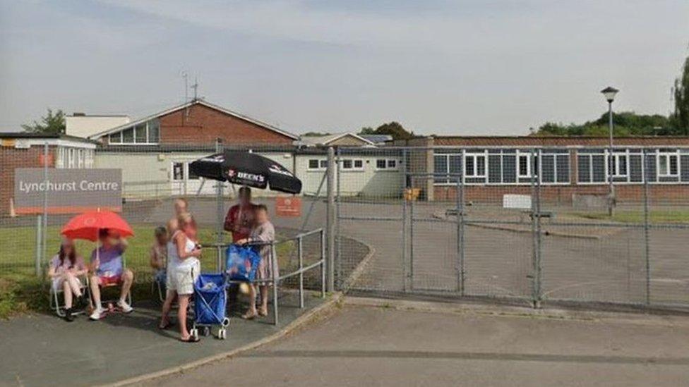 Google Maps image of the closed Lyndhurst Centre in Park North with people waiting outside the gates