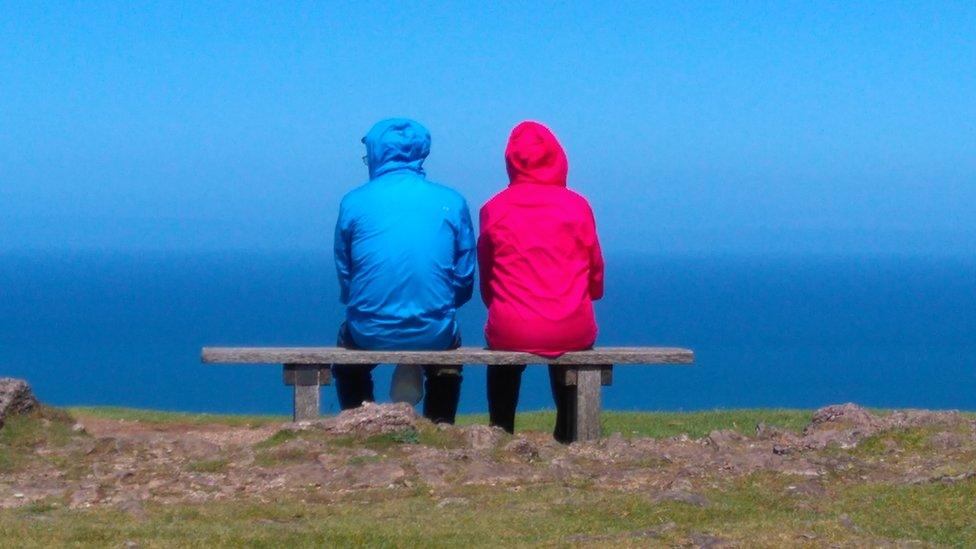 A couple in brightly coloured coats