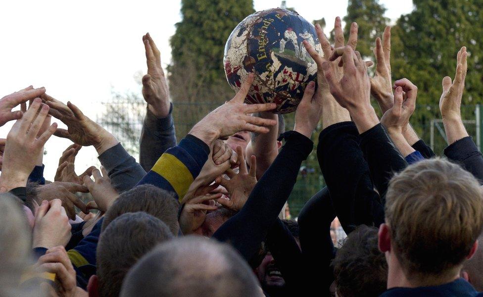 Opposing teams of the Up'ards and the Down'ards compete at the start of the annual Royal Shrovetide Football Match in Ashbourne in 2015