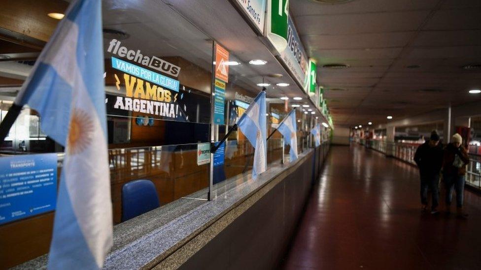 Commuters walk at the closed Retiro bus terminal in Buenos Aires on June 25, 2018