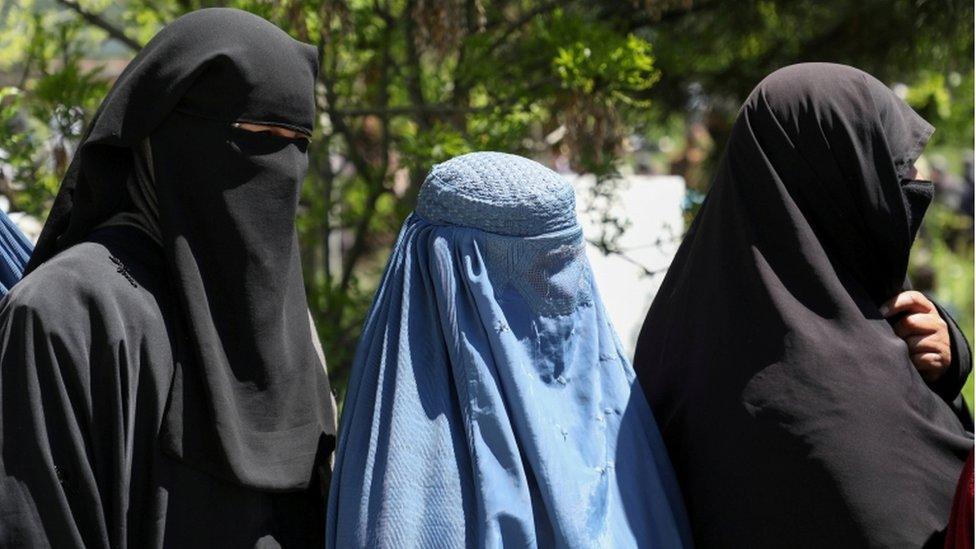 Afghan women wait in line for wheat, April 2021