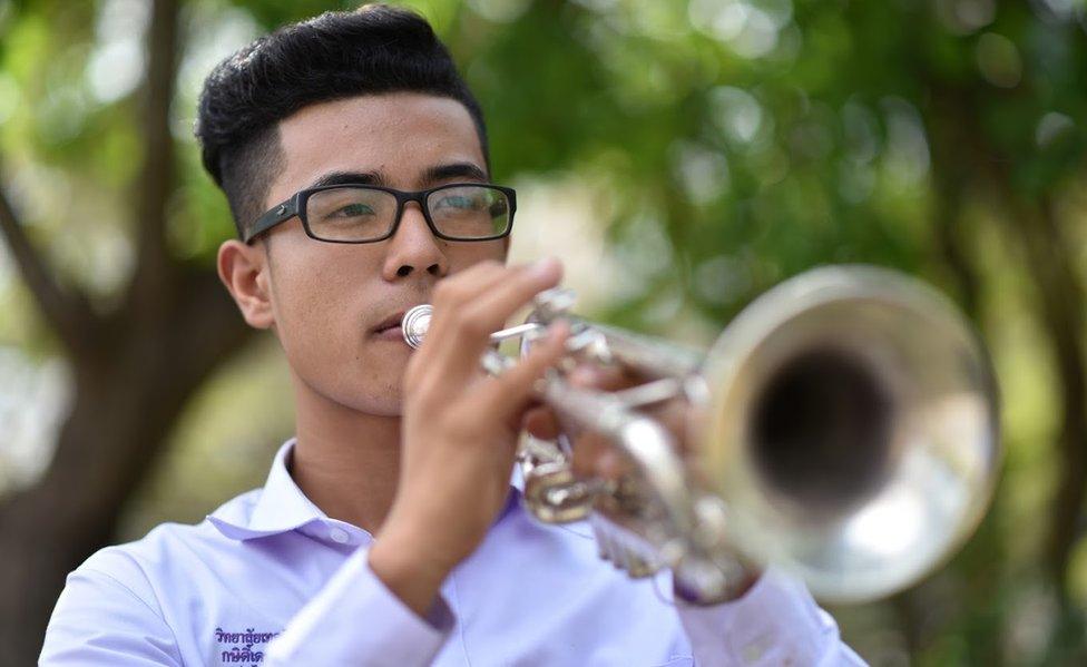 Kasidach pictured playing the trumpet outdoors