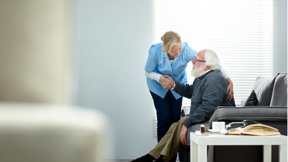 Elderly man with care worker