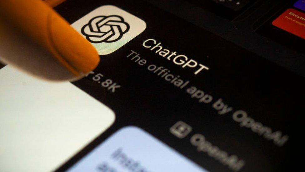 A woman about to open the ChatGPT app on her phone