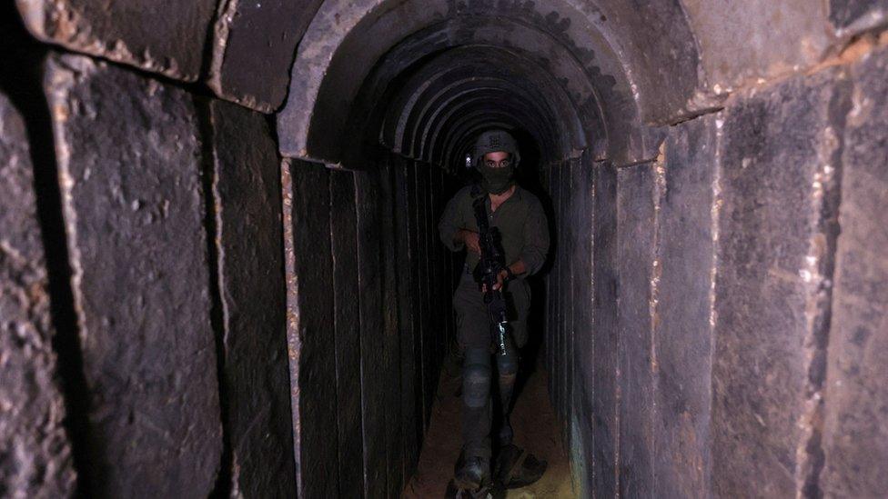 An IDF soldier walks through a captured Hamas tunnel