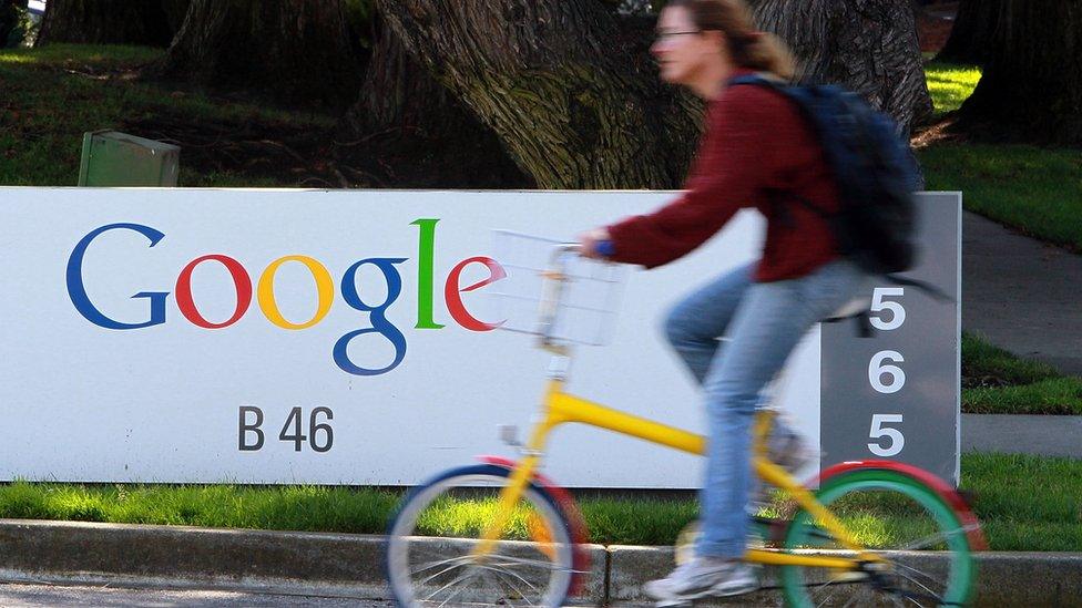 Cyclist rides past Google sign in Mountain View