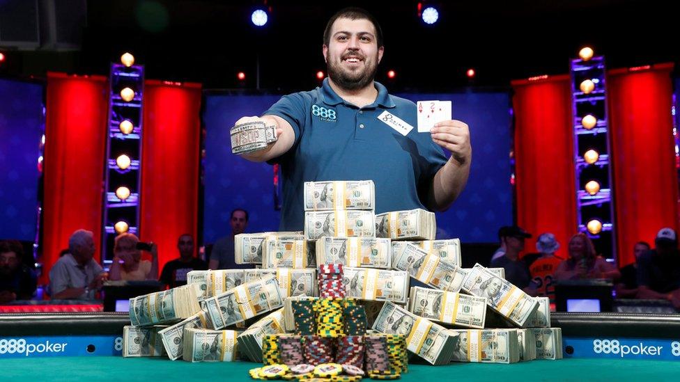 man with pile of money, gemstone bracelet, and an Ace of hearts and Two of diamonds