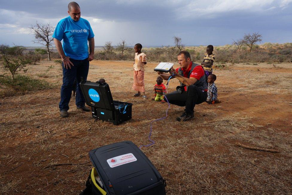 Men setting up mobile network in Sudan