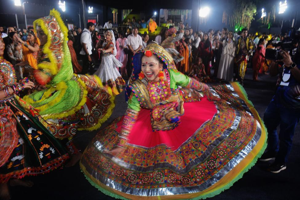 People wear traditional dress on the first day of the nine-day Navratri festival, at Modella Mill Compound in Mumbai, India.