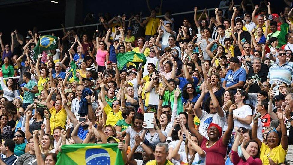 Spectators cheer during the Rio 2016 Paralympic Games at Olymic stadium on September 9, 2016