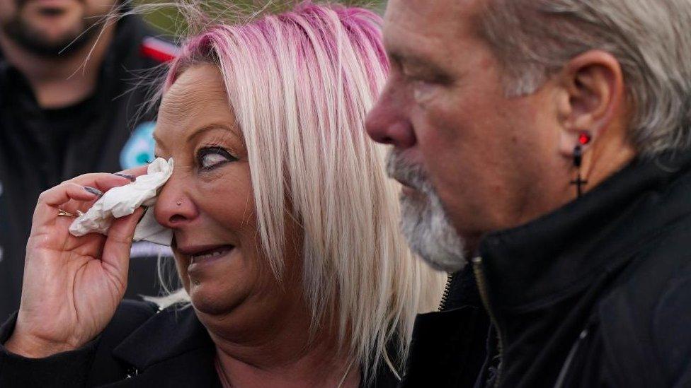 Charlotte Charles wipes away a tear during her son's funeral