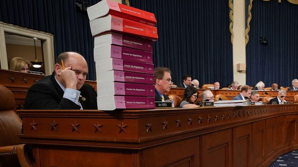 House Ways and Means Committee member Rep. Tom Reed (R-NY) keeps a stack of books that document the current federal tax code and related regulations on his desk during the first markup of the proposed GOP tax reform legislation in the Longworth House Office Building on Capitol Hill November 6, 2017 in Washington, DC.