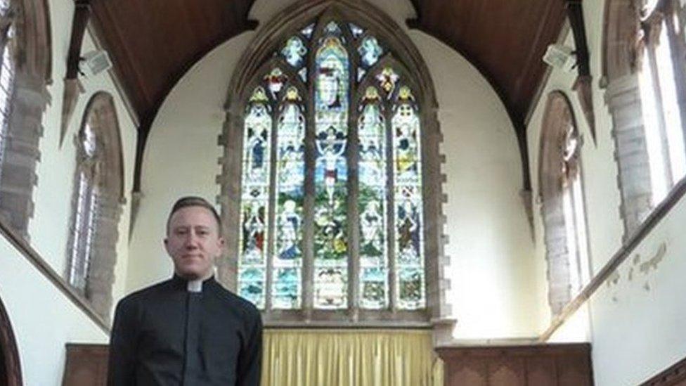 Father David Morris with the WW1 memorial window at St Paul's Church in Grangetown