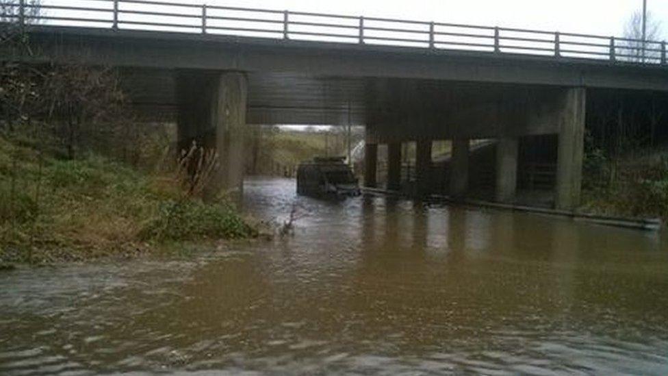 A van submerged in floodwaters