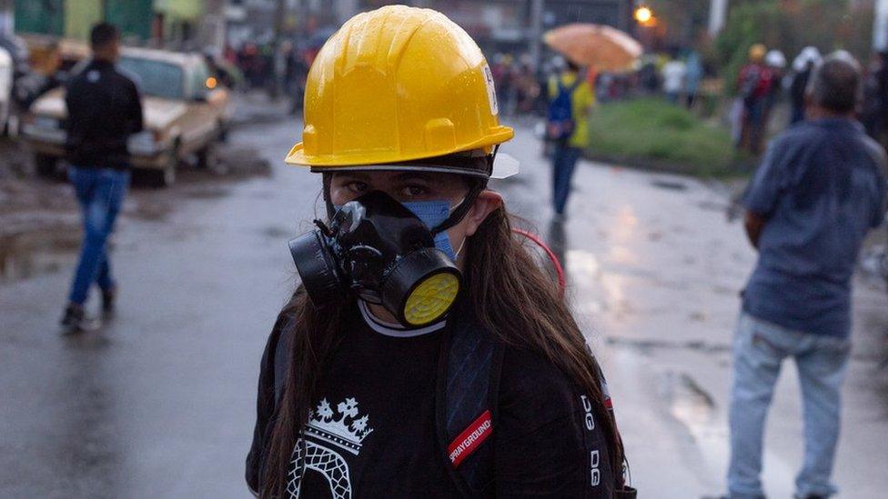 A protester wearing a gas mask in Medellín on 2 June 2021