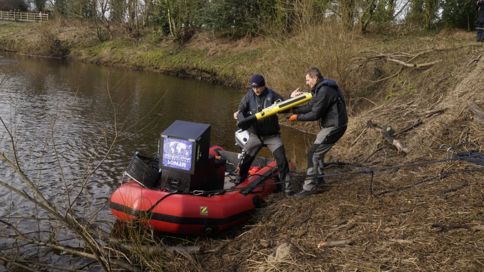 Divers load equipment on to a boat