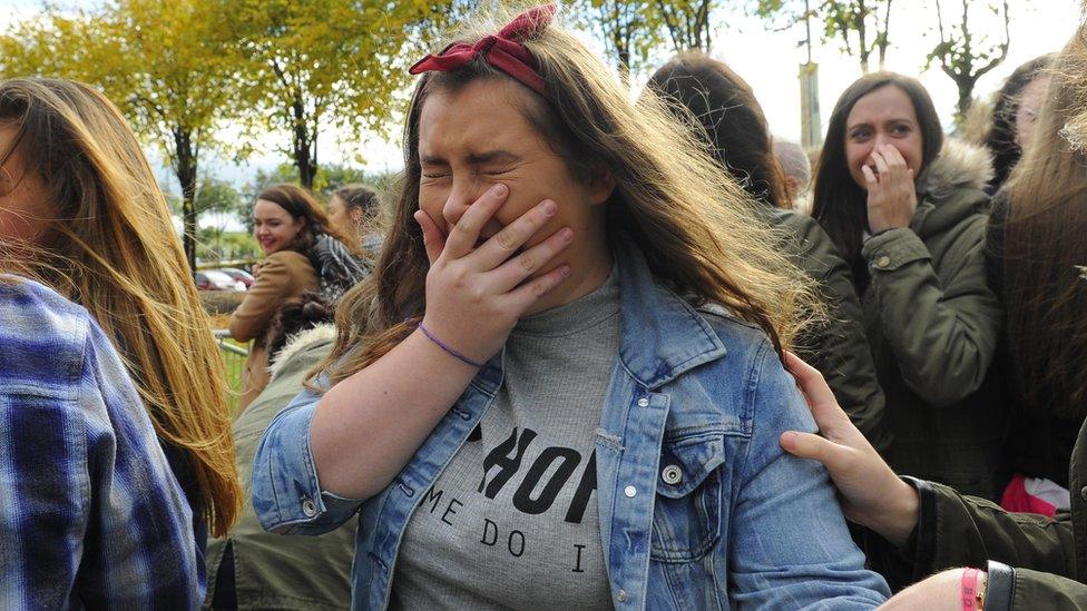 A One Direction fan crying outside the SSE Arena