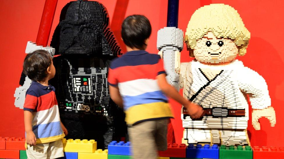 Young boys look at lego-made Darth Vader (L) and Luke Skywalker (R), characters in the US movie 'Star Wars' at LegoLand in Tokyo on 15 September 2013