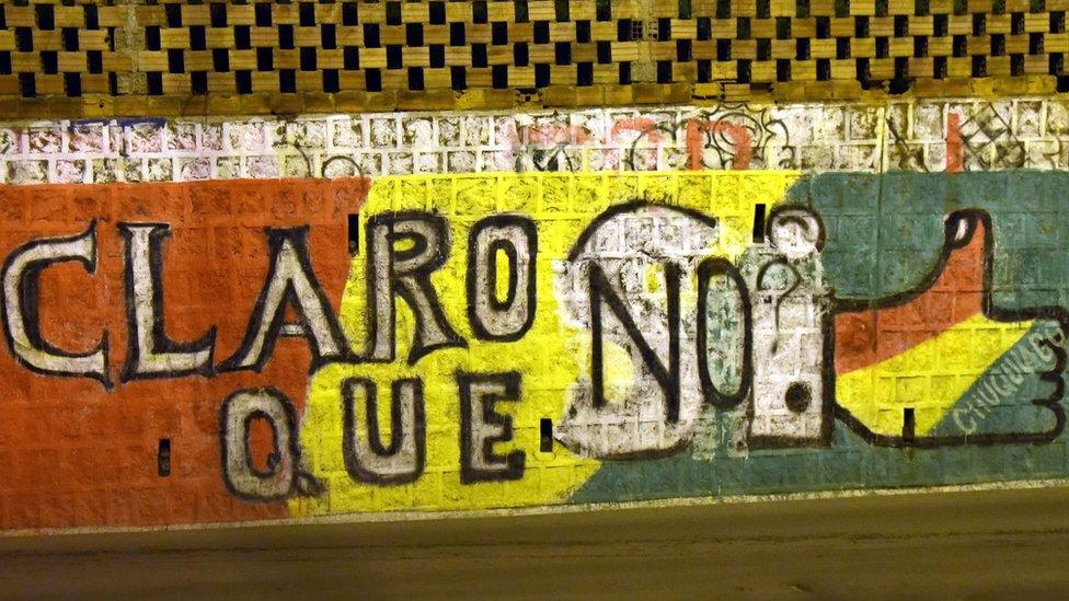 An intervened campaign wall in opposition to the Bolivian referendum is seen in El Alto, Bolivia