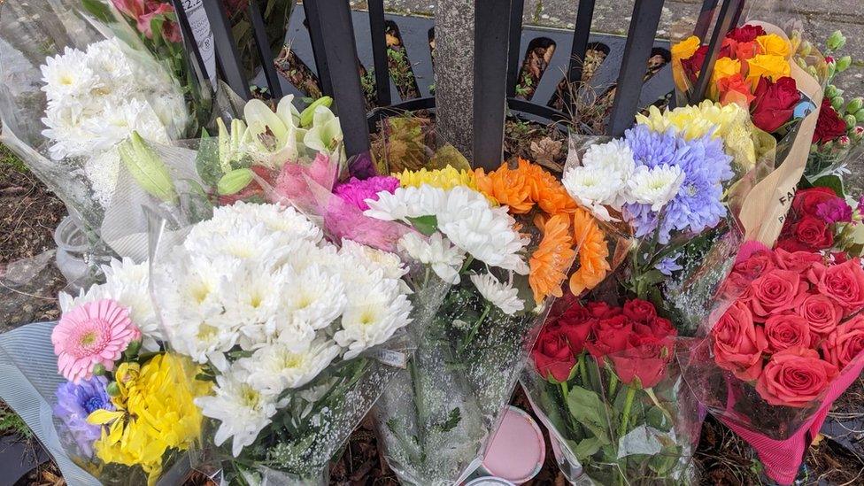 Flowers tied to railings