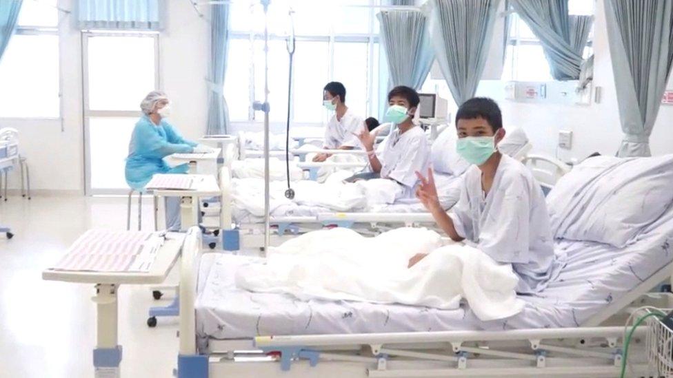 A screen grab shows boys rescued from the Thai cave wearing mask and resting in a hospital in Chiang Rai