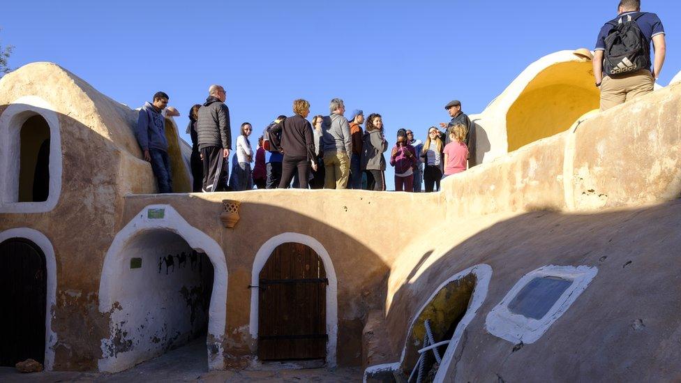 Tourists at Ksar Haddada in Tunisia where part of the Star Wars series was filmed