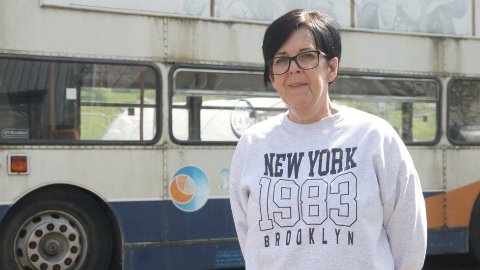 Dawn Emmerson, project coordinator stands in front of the disused Stagecoach bus