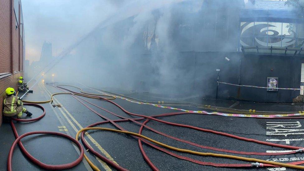 Firefighters putting water on the fire