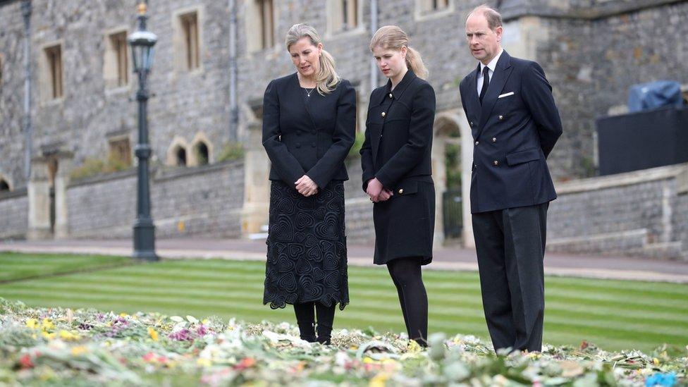 The Countess of Wessex, Lady Louise Windsor and the Earl of Wessex view flowers outside St George's Chapel, at Windsor Castle, on 16 April 2021