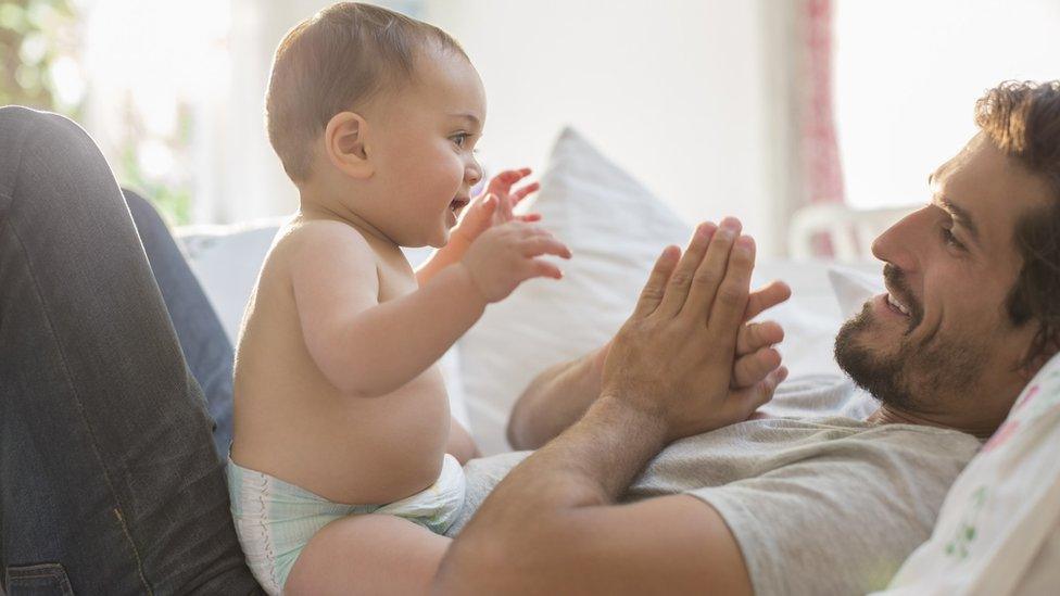 A father playing with his baby