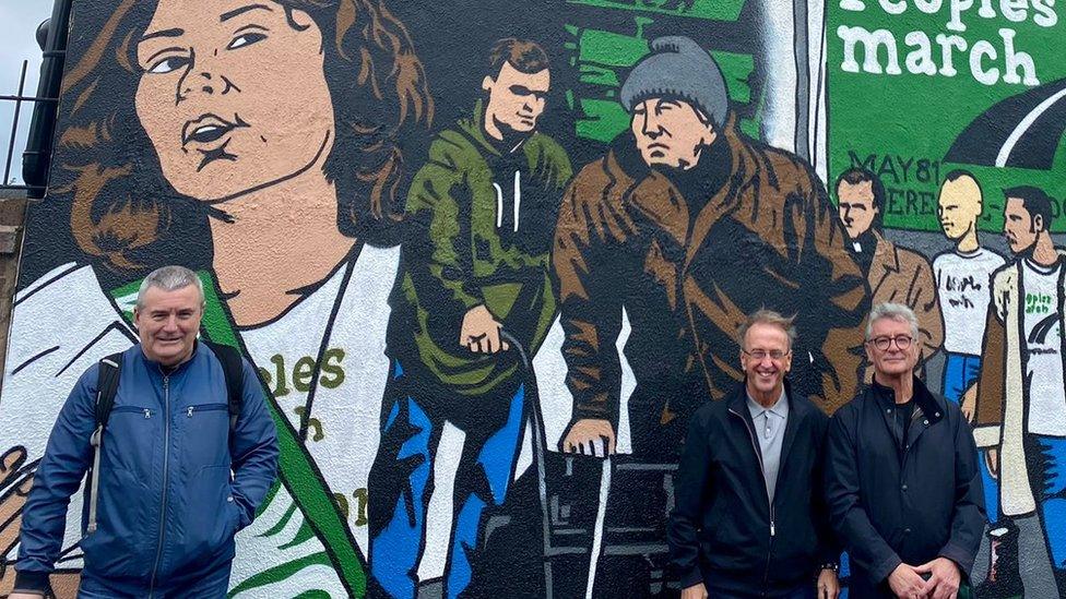 Keith Mullen, George Allen and John Williams in front of a mural celebrating the People's March For Jobs