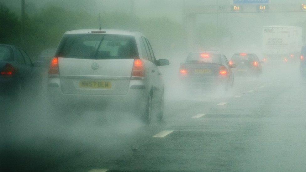 Cars driving in heavy rain on a motorway