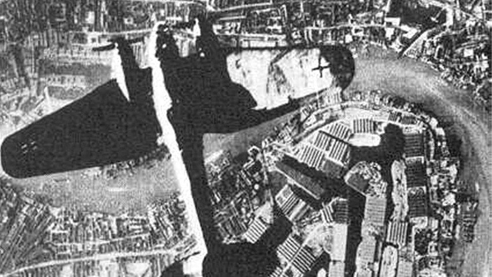 A plane flying over London during the Blitz.