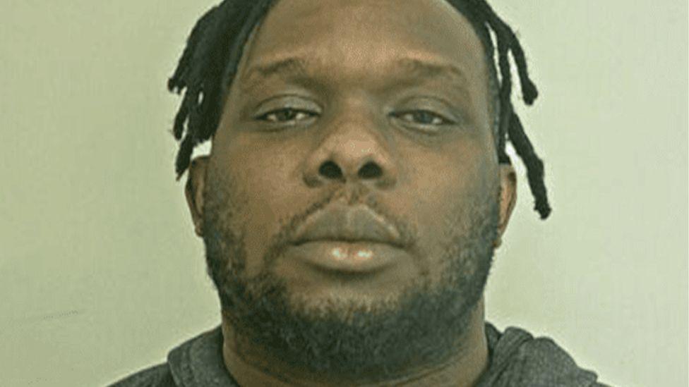 Mugshot of Joel Mtebe who is wearing a grey hoodie and has dark hair